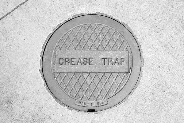grease trap pumping involves removing the accumulated grease and waste from the trap to prevent clogs and backups